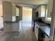 Bright kitchen with white cabinets, dark countertops, and modern black appliances at 24257 Austin Rd, Albemarle, NC 28001