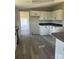 A well-lit kitchen featuring white cabinets, dark countertops, and modern flooring at 24257 Austin Rd, Albemarle, NC 28001