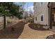A meticulously landscaped backyard with stone steps and a gravel path, creating a serene and inviting outdoor space at 3196 Stonemill Path, Sherrills Ford, NC 28673