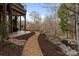 A beautifully landscaped backyard with a winding gravel path, leading to a relaxing outdoor patio area at 3196 Stonemill Path, Sherrills Ford, NC 28673