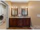 Bathroom features double sinks with framed mirrors above matching wood vanities and tile flooring at 3196 Stonemill Path, Sherrills Ford, NC 28673