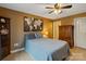 A cozy bedroom features a large bed, a tall armoire, a bookcase, and artwork at 3196 Stonemill Path, Sherrills Ford, NC 28673