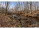 A tranquil creek flowing through the property's natural landscape, enhancing its peaceful setting at 3196 Stonemill Path, Sherrills Ford, NC 28673