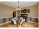 Inviting dining area with glass table, modern chandelier, and decorative wall art at 3196 Stonemill Path, Sherrills Ford, NC 28673