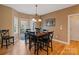 Cozy dining room with hardwood floors, chandelier, and access to an outdoor balcony at 3196 Stonemill Path, Sherrills Ford, NC 28673