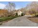 Long driveway leading to a lovely home surrounded by trees and blooming flowers at 3196 Stonemill Path, Sherrills Ford, NC 28673