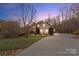 A charming home with manicured landscaping, a circular driveway, and a welcoming exterior aesthetic at 3196 Stonemill Path, Sherrills Ford, NC 28673