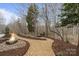 Scenic outdoor area with a custom fire pit, gravel path, and lush landscaping at 3196 Stonemill Path, Sherrills Ford, NC 28673