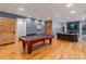 Large game room featuring a pool table, rustic barn door, and a cozy seating area with fireplace at 3196 Stonemill Path, Sherrills Ford, NC 28673