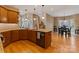 Bright kitchen with island, hardwood floors, and a view of the dining area and backyard at 3196 Stonemill Path, Sherrills Ford, NC 28673