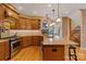 Open kitchen with a large island, stone backsplash, stainless steel appliances, and hardwood floors at 3196 Stonemill Path, Sherrills Ford, NC 28673
