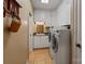 Laundry room with white cabinetry, stainless steel appliances, and tile flooring at 3196 Stonemill Path, Sherrills Ford, NC 28673