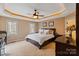 Comfortable bedroom with tray ceilings, neutral colors, and ample natural light from two windows at 3196 Stonemill Path, Sherrills Ford, NC 28673