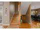 Wooden staircase with decorative wood trim and lighting showcasing hardwood floors at 3196 Stonemill Path, Sherrills Ford, NC 28673