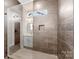 Modern bathroom with tiled shower, glass door, and a small window for natural light at 4029 Miller Rd, Salisbury, NC 28147