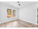 Bedroom with a ceiling fan, large windows, and light colored wood floors at 4029 Miller Rd, Salisbury, NC 28147