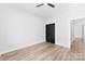 Bedroom with a ceiling fan, light colored wood floors, and dark colored closet doors at 4029 Miller Rd, Salisbury, NC 28147