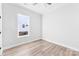 Well-lit bedroom with hardwood floors, a window, and freshly painted white walls at 4029 Miller Rd, Salisbury, NC 28147