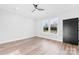 Light-filled bedroom with hardwood floors, white trim, and a view of the backyard through a large window at 4029 Miller Rd, Salisbury, NC 28147