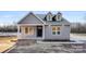 Close up of home featuring a covered porch and black front door at 4029 Miller Rd, Salisbury, NC 28147