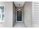 View of the home's covered entryway with modern light fixture and door at 4029 Miller Rd, Salisbury, NC 28147