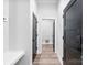 Hallway with light colored wood floors and dark colored doors at 4029 Miller Rd, Salisbury, NC 28147