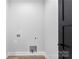 Laundry room with washer and dryer hookups, outlets, and a dark colored door at 4029 Miller Rd, Salisbury, NC 28147