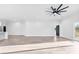 Bright open-plan living room featuring wood-look floors and modern ceiling fan at 4029 Miller Rd, Salisbury, NC 28147