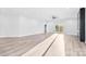 Open living room with wood-look flooring, modern fireplace, and sliding glass doors at 4029 Miller Rd, Salisbury, NC 28147