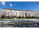 Attractive multi-story brick building in spring, surrounded by flowering trees under a blue sky at 404 N Laurel Ave # 12, Charlotte, NC 28204