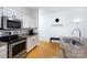 Kitchen featuring stainless steel appliances, granite countertops, and hardwood floors at 404 N Laurel Ave # 12, Charlotte, NC 28204