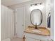 Bathroom featuring a white vanity with a granite top and modern oval mirror at 4137 Whitney Nw Pl, Concord, NC 28027