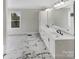 Bright bathroom with double sinks, modern fixtures, and stylish marble floors at 510 Newport Dr, Salisbury, NC 28144