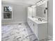 Bright bathroom featuring a dual sink vanity, large mirror, and elegant marble flooring at 510 Newport Dr, Salisbury, NC 28144