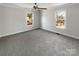 Neutral bedroom with plush carpet, a ceiling fan, and natural light streaming in from two windows at 510 Newport Dr, Salisbury, NC 28144