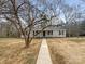 A charming single-story house with a walkway framed by a mature tree and a well-manicured lawn at 510 Newport Dr, Salisbury, NC 28144