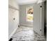 Well-lit laundry room with a window, vinyl flooring, and wire shelving, offering functionality and convenience at 510 Newport Dr, Salisbury, NC 28144