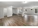 Open-concept living room with wood-look flooring, neutral walls, and sight lines to the kitchen at 510 Newport Dr, Salisbury, NC 28144