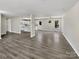 Bright and open living area, with sleek vinyl flooring and light-filled windows, flowing into a well-lit kitchen at 510 Newport Dr, Salisbury, NC 28144