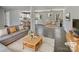 Open-concept living room with modern gray sofa and dining area with updated flooring at 510 Newport Dr, Salisbury, NC 28144
