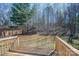 View from a wood deck overlooking the serene, wooded backyard of this home at 570 N Rhyne St, Gastonia, NC 28054