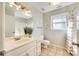 Well-lit bathroom with a white vanity, tiled floor, and shower-tub combination at 6008 Lanai Ln, Tega Cay, SC 29708