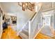 Inviting staircase with hardwood floors and stone fireplace, leading to the upper levels of the home at 6008 Lanai Ln, Tega Cay, SC 29708