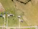 High aerial view of multiple homes on expansive acreage, offering privacy and space at 6808 Austin Grove Church Rd, Marshville, NC 28103
