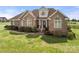 Charming brick home with a lush lawn and carefully designed landscaping at 6808 Austin Grove Church Rd, Marshville, NC 28103