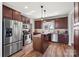 Modern kitchen featuring stainless steel appliances, dark cabinets, and a center island with bar seating at 6808 Austin Grove Church Rd, Marshville, NC 28103