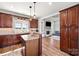 Well-appointed kitchen with dark wood cabinets, granite counters, and a view into the living room at 6808 Austin Grove Church Rd, Marshville, NC 28103