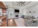 Cozy living room featuring a stone fireplace, hardwood floors, and a tray ceiling at 6808 Austin Grove Church Rd, Marshville, NC 28103