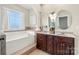 Bright main bathroom offers double sinks, soaking tub, and decorative columns at 6808 Austin Grove Church Rd, Marshville, NC 28103
