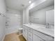 Modern bathroom features double sink vanity, a large mirror, and a tub with shower at 7120 Saltpeter St, Charlotte, NC 28215